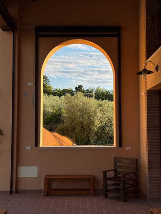 View of olive trees through an arch at Collina dei Poeti vineyard in Santarcangelo di Romagna – Emilia-Romagna with kids travel guide